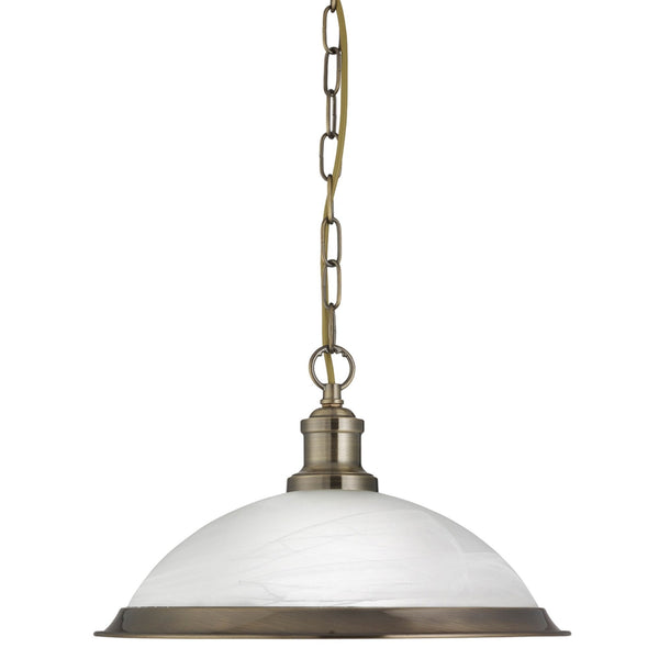A single pendant light with a white dome shade and antique brass chain and trim.