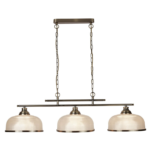 A close up of an antique bronze light with three downward facing glass lights.