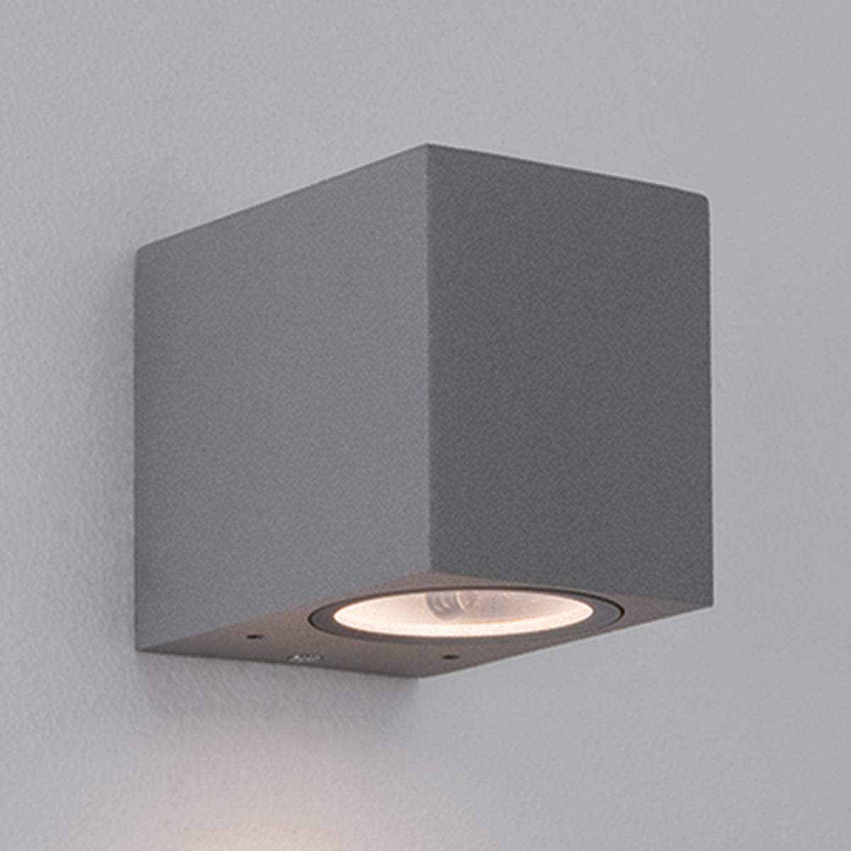 Grey square wall light with a single downward-facing bulb