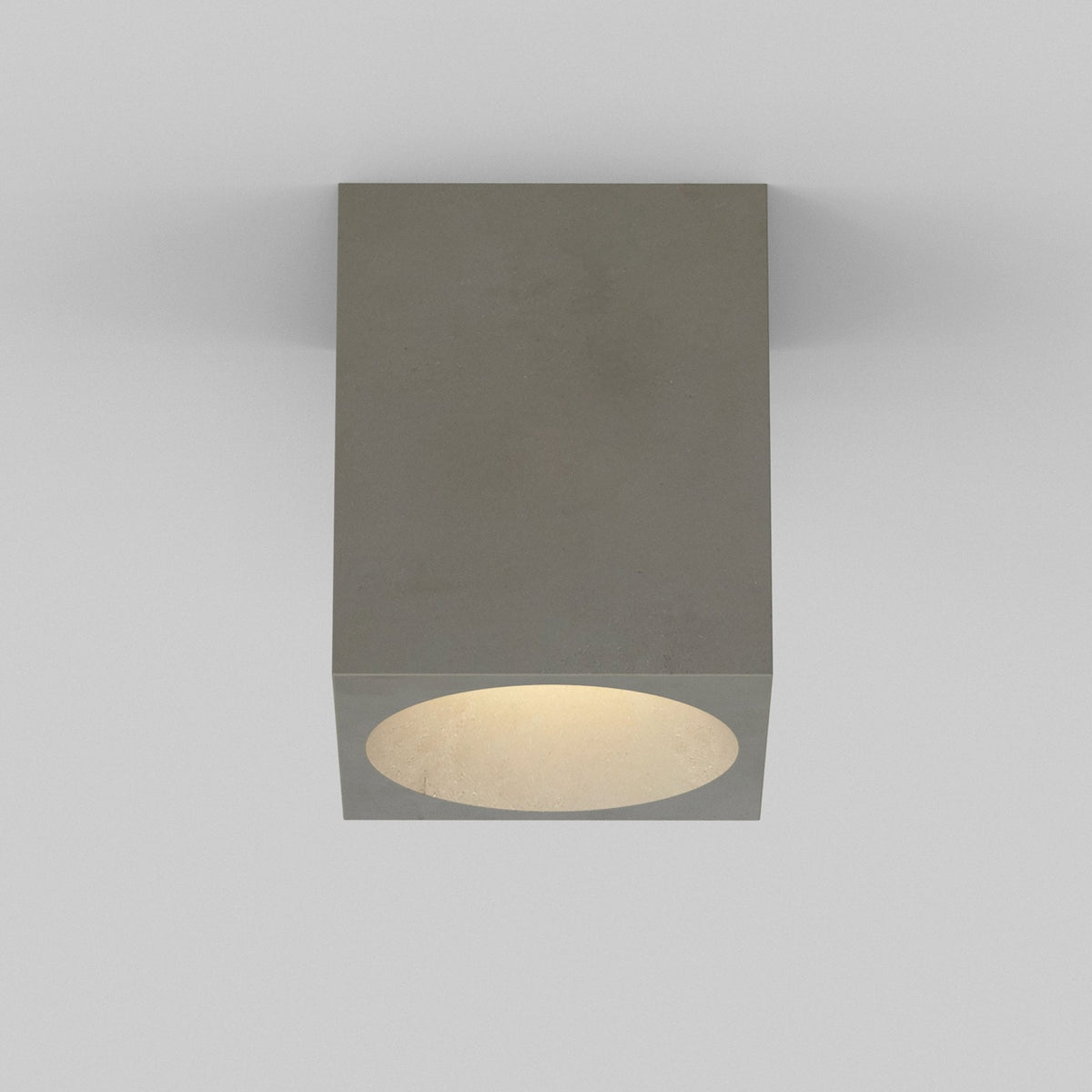 Square concrete ceiling light with a circular opening and warm light