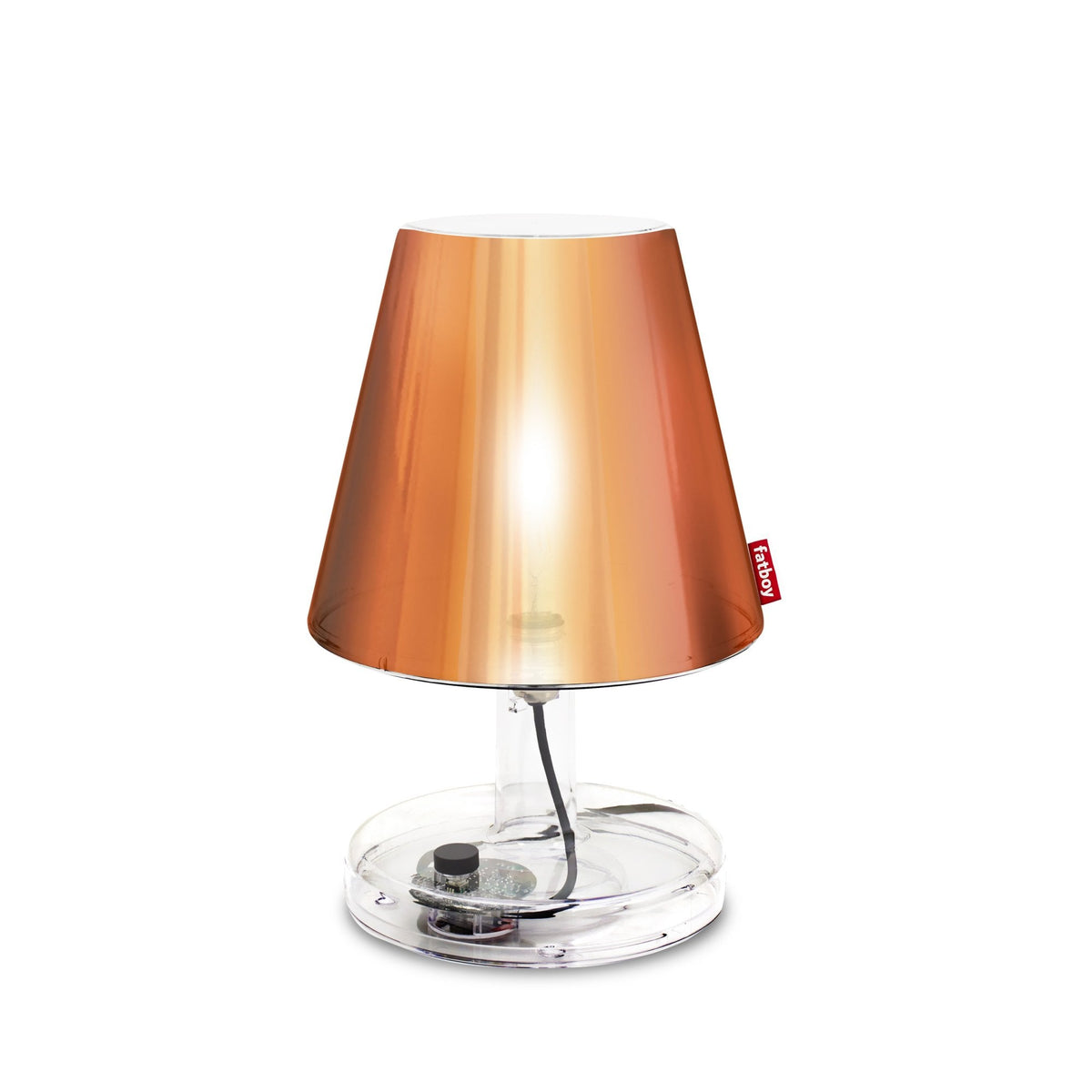 A modern copper-coloured table lamp with a transparent base and a visible power cord.