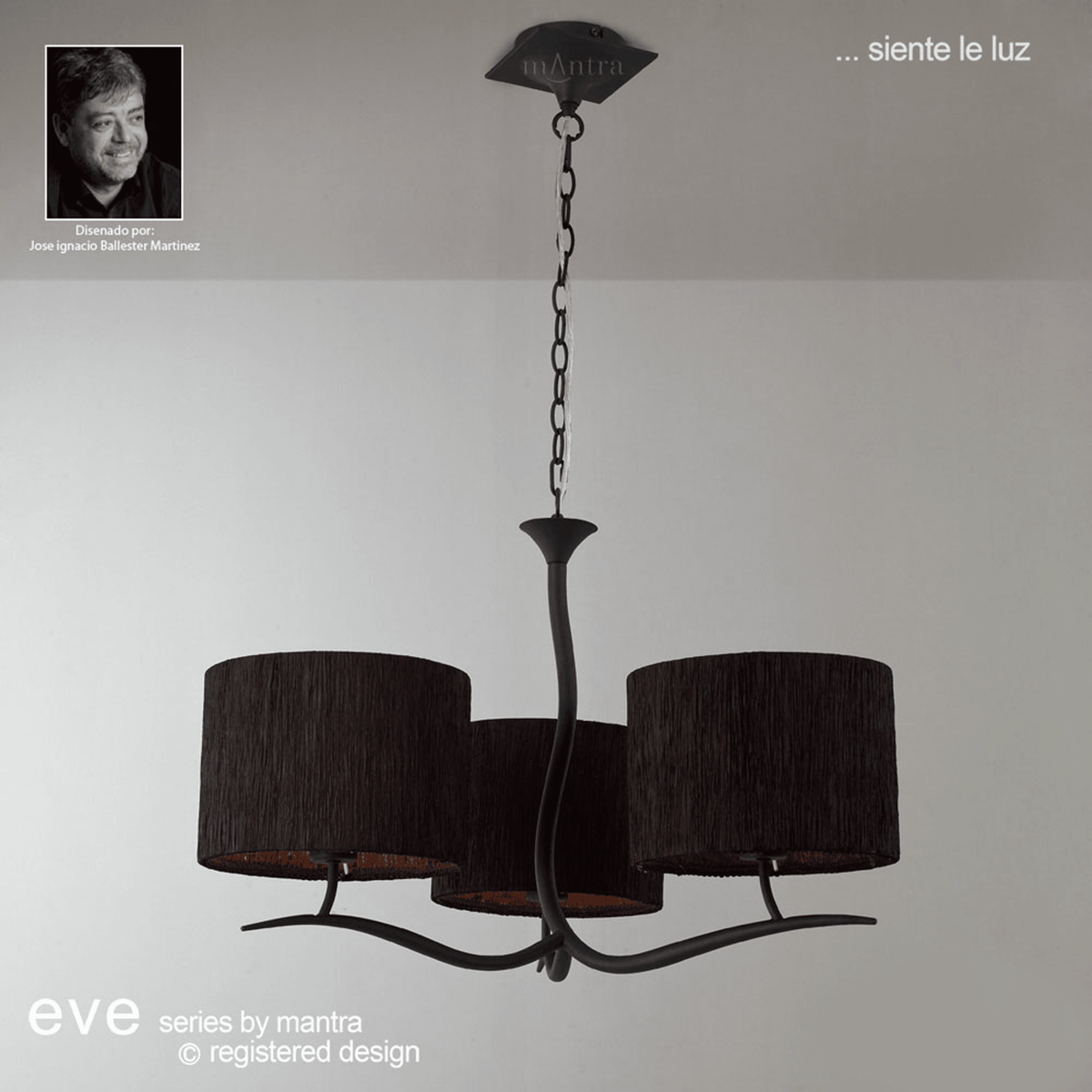 A sophisticated chandelier with three dark fabric shades, exuding a warm, inviting glow.