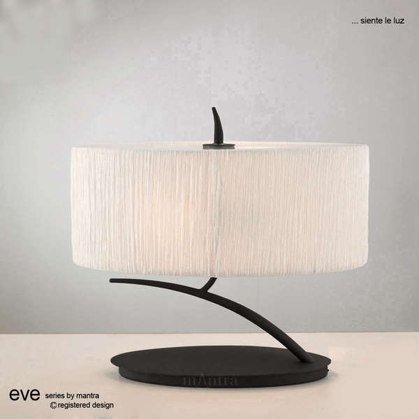 Table lamp with an oval, off-white fabric shade and a black curved base.