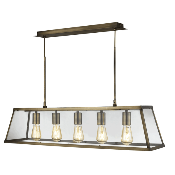 A close-up of a brass-effect linear kitchen island pendant light with five bulbs.