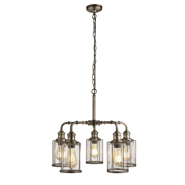 An industrial-style five-light chandelier with clear seeded glass shades and an antique brass finish.