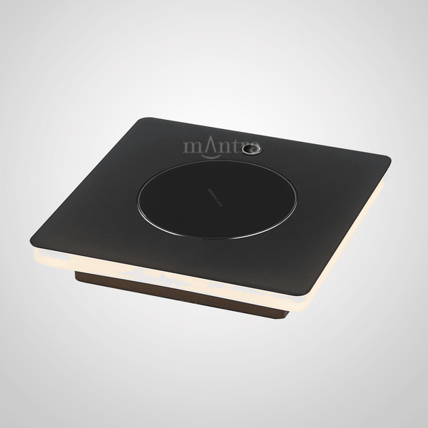 A sleek, square black lamp with a circular light in the centre, designed for modern interiors.