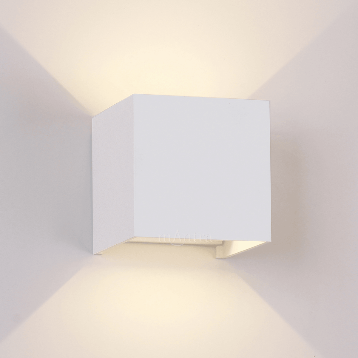 A close-up of a white square wall light casting light in two directions.
