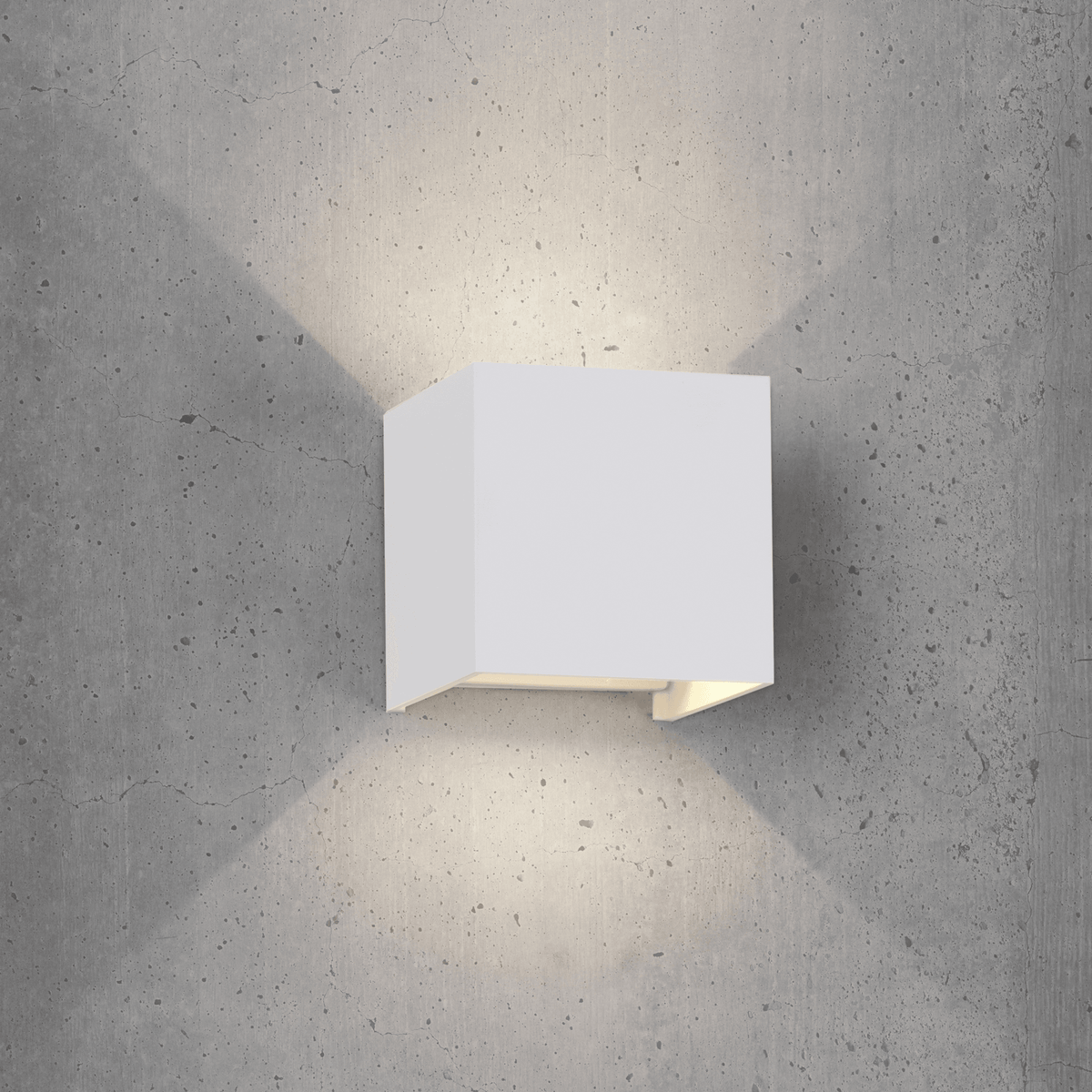 A square white wall light mounted on a grey concrete wall, casting light upwards and downwards.