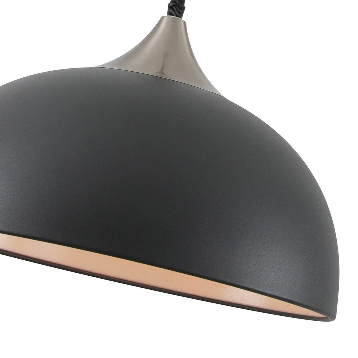 Close-up of a black dome pendant light with a silver top, showcasing the texture.