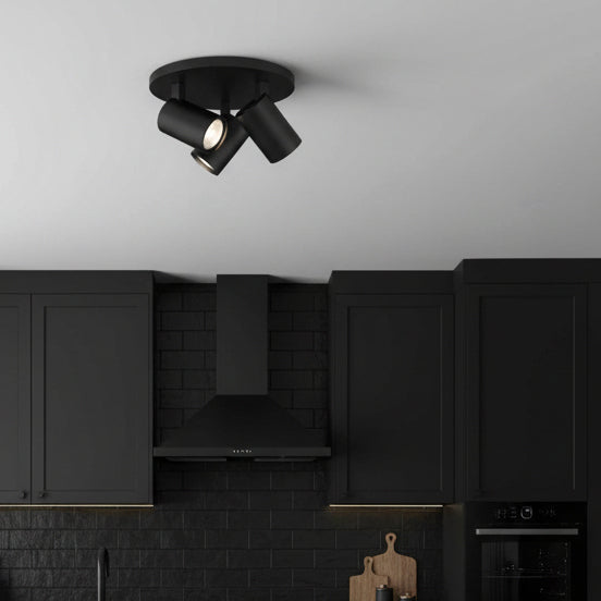 Black ceiling light with three adjustable spotlights in a modern kitchen