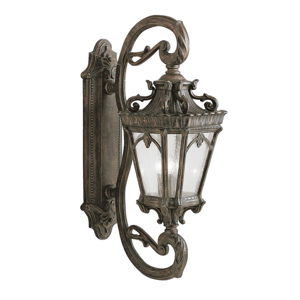 An ornate bronze outdoor wall light on a white background.