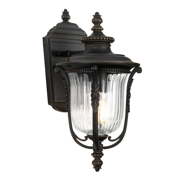 A classic outdoor wall light in black with clear fluted glass and decorative finials.