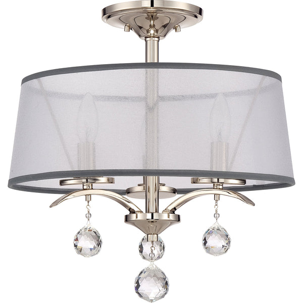 A close-up of a glamorous ceiling light fixture with a sheer drum shade and crystal drops.