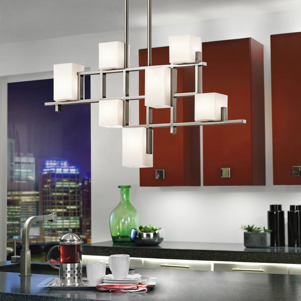A modern rectangular chandelier with multiple frosted glass cubes, lighting a contemporary kitchen.