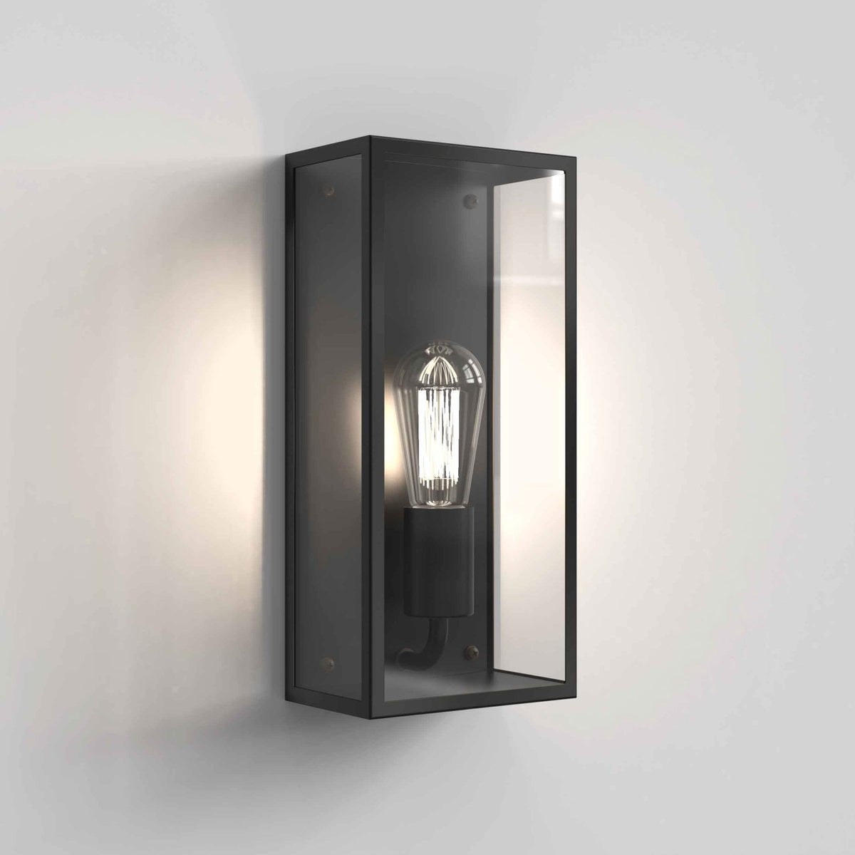 Black rectangular outdoor wall light with clear glass panels and an exposed filament bulb