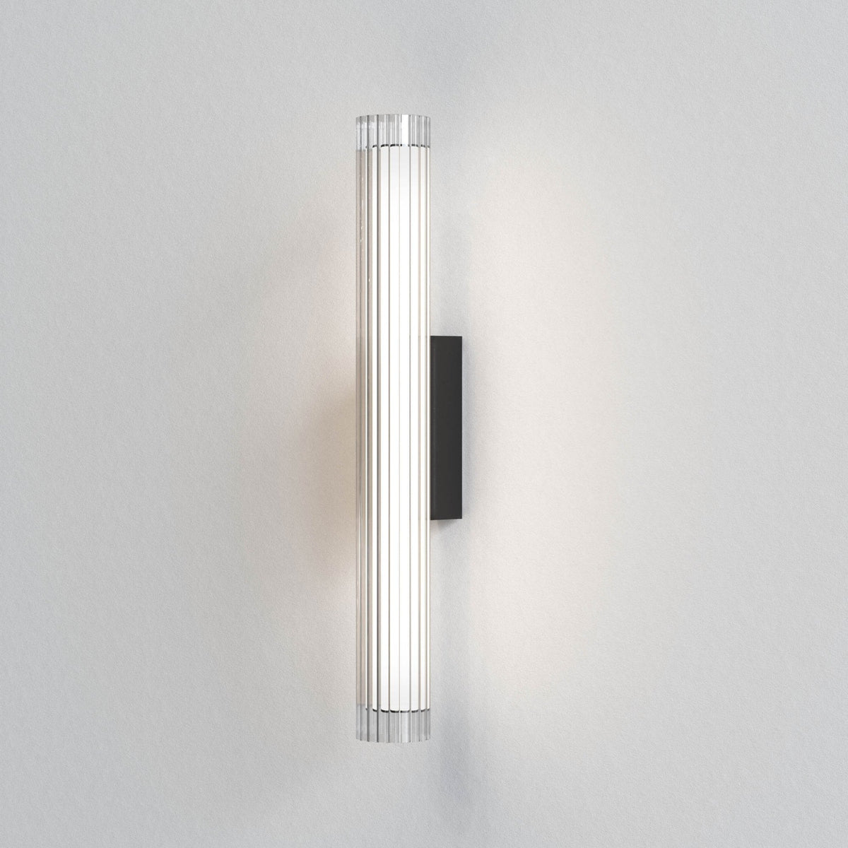 Vertical wall light with a clear ribbed glass shade and a black rectangular base