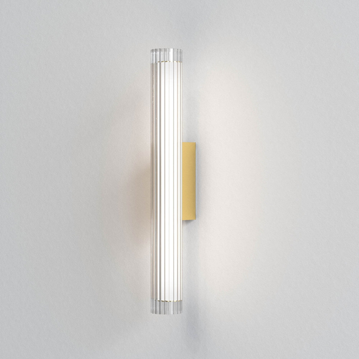 Vertical fluted glass wall light with a rectangular brass backplate