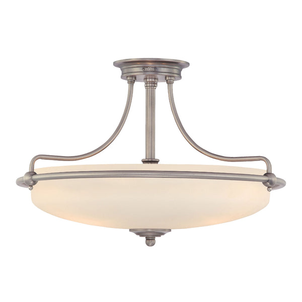 A close-up of a semi-flush ceiling light fixture with a brushed nickel finish and an alabaster glass shade.