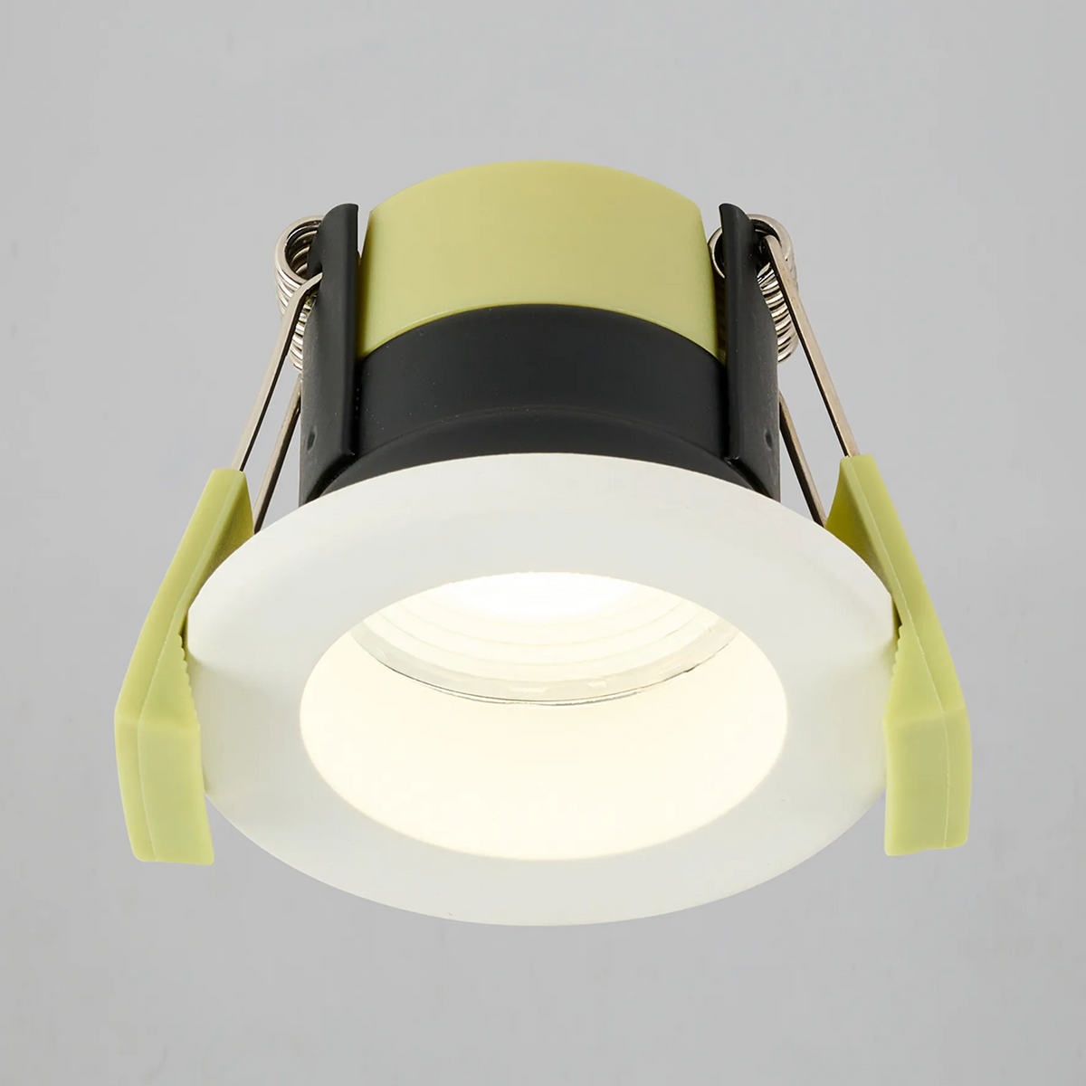 Warm white LED recessed light with a white trim and lime green clips