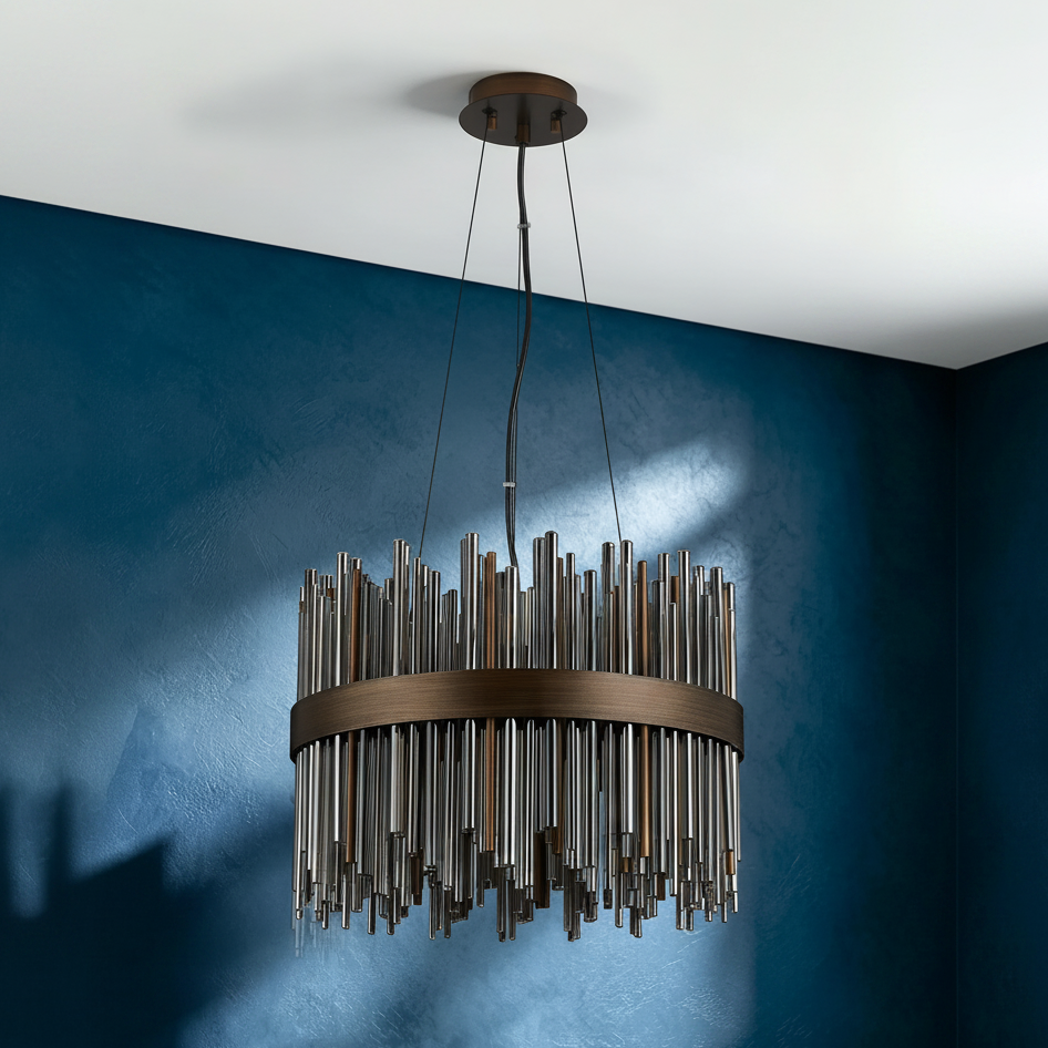 Round chandelier with bronze frame and hanging metal rods in varying lengths and finishes