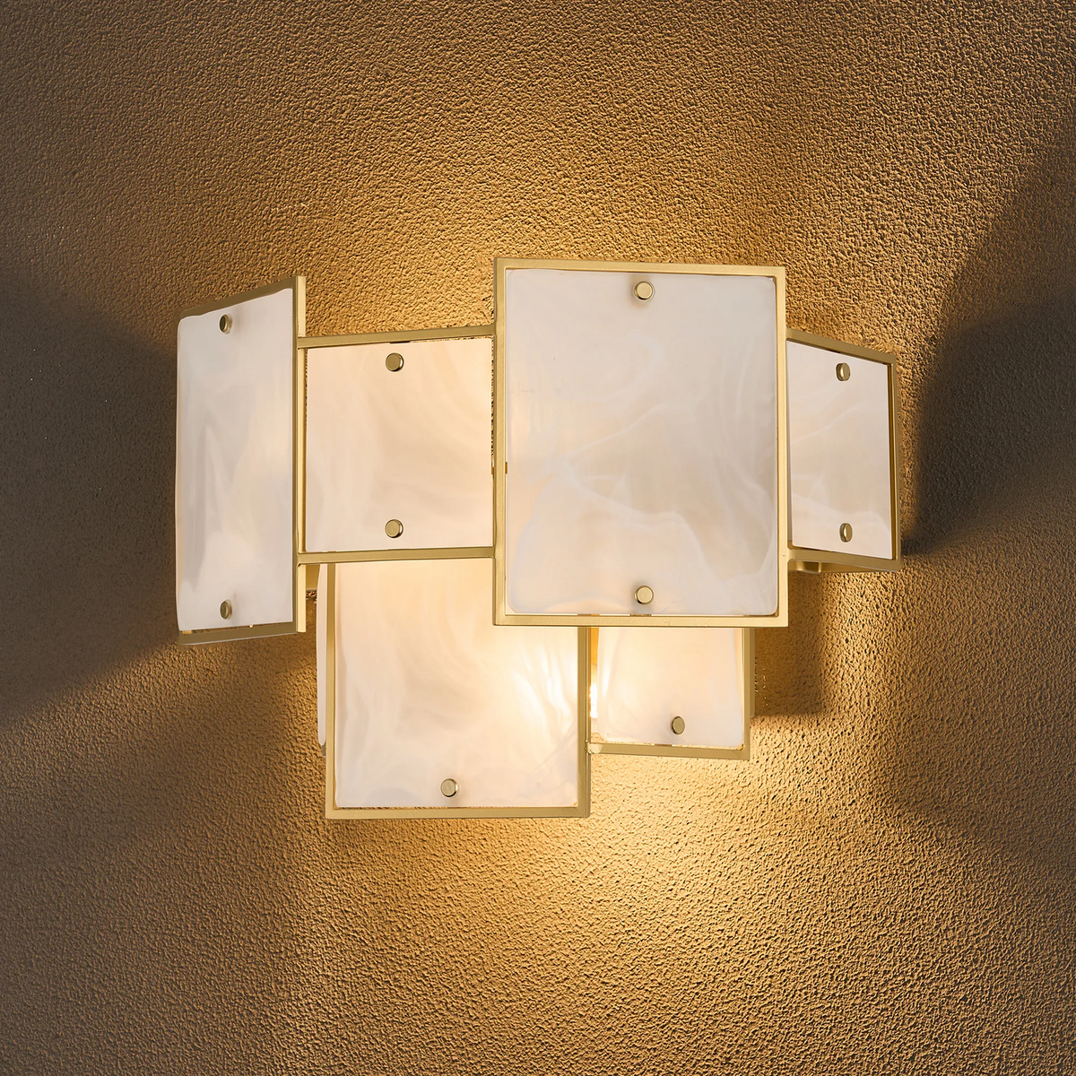 Wall sconce with rectangular white glass panels and gold frames