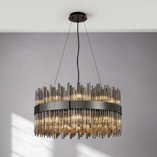 Round chandelier with dark metal frame and multiple clear glass rods hanging down, illuminated from within