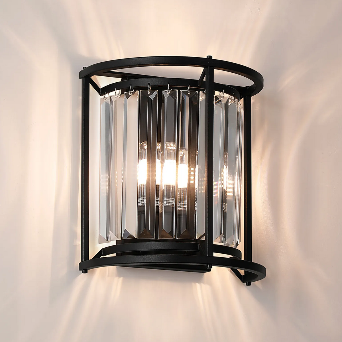 Black metal wall sconce with clear rectangular crystal accents and two illuminated bulbs