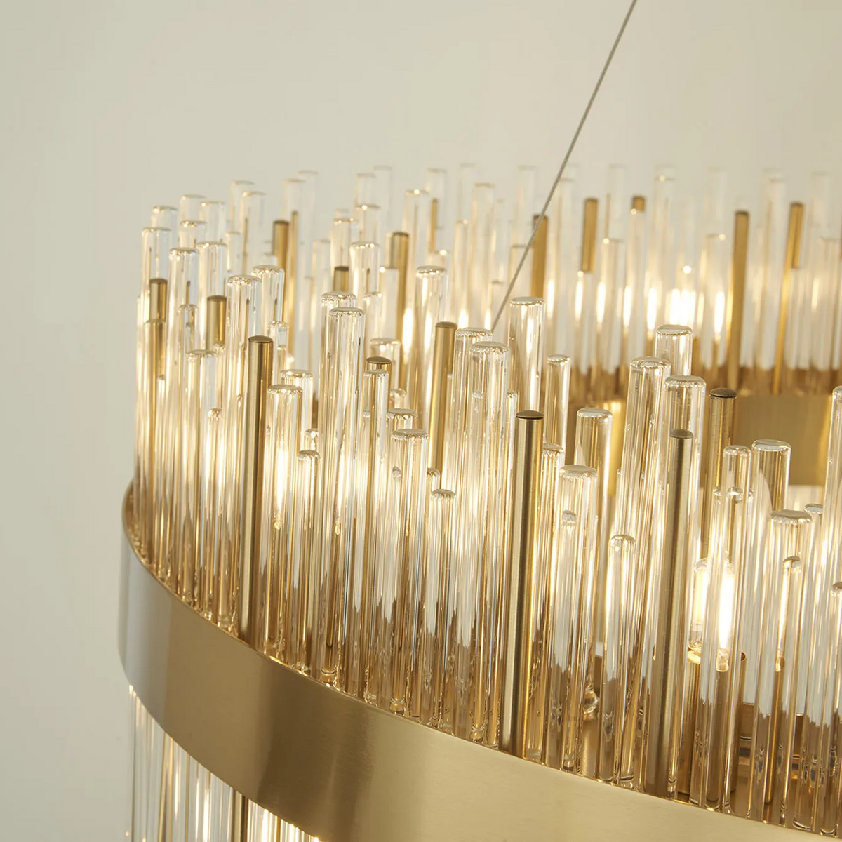 Close-up of a gold chandelier with many glass rods and internal lights