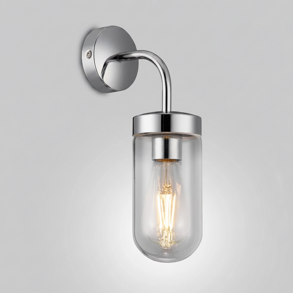 Chrome wall light with a clear glass shade and exposed filament bulb