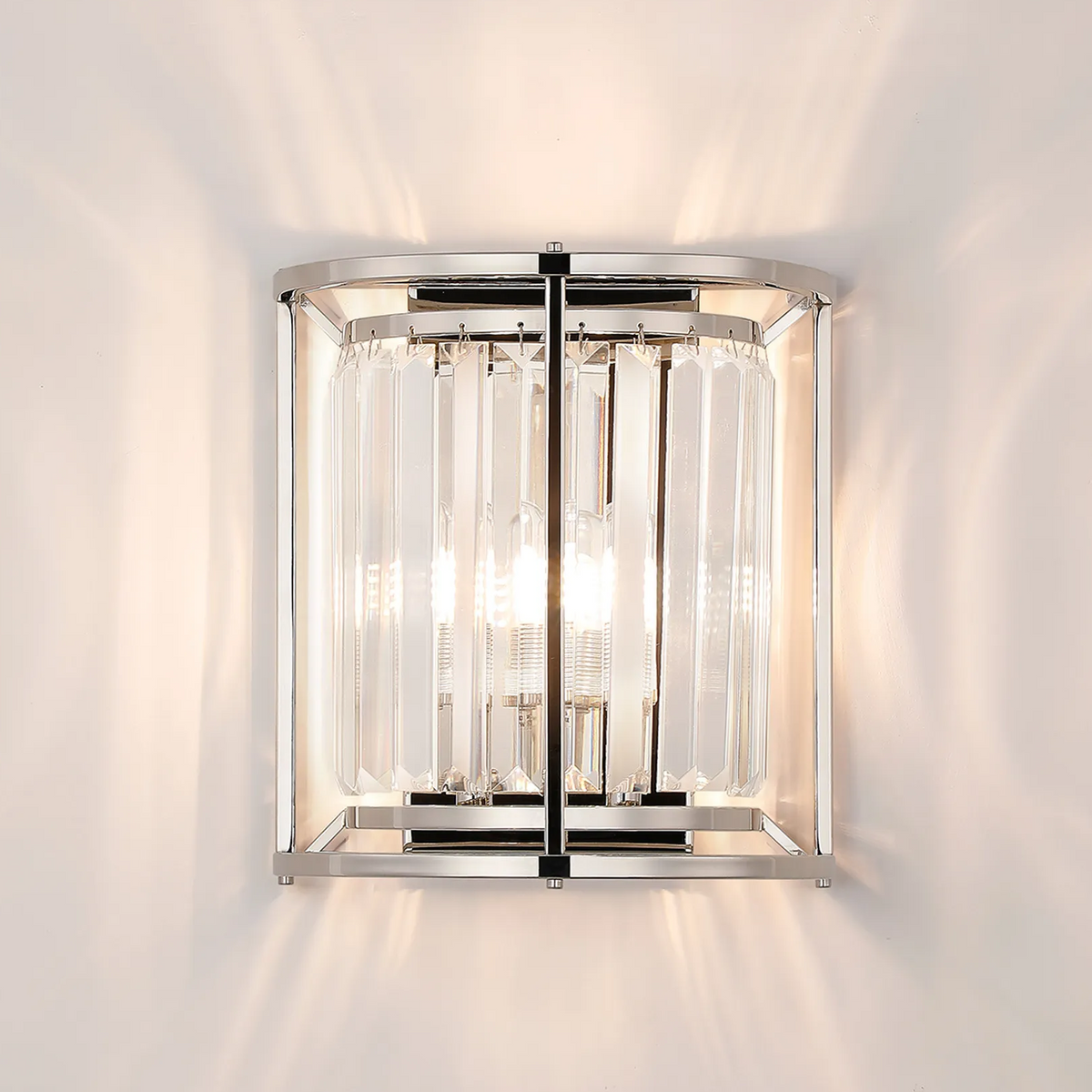 Chrome wall sconce with clear glass panels and two exposed bulbs