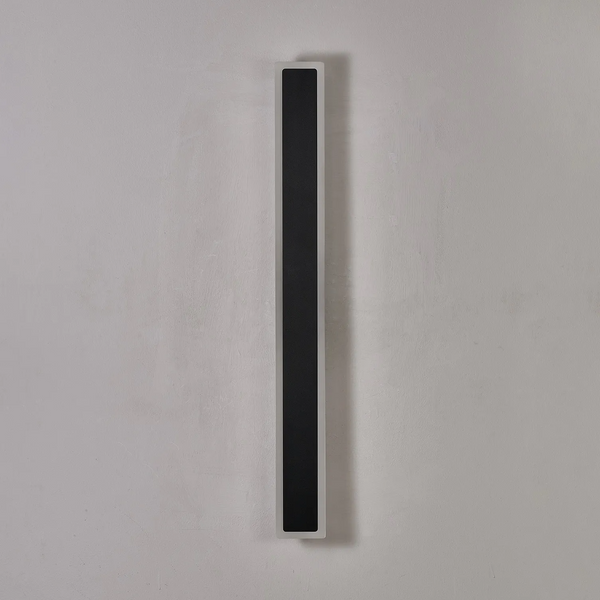 Vertical black and white wall light on a grey wall