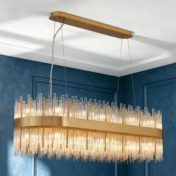 Rectangular gold chandelier with multiple clear glass rods hanging from a gold base