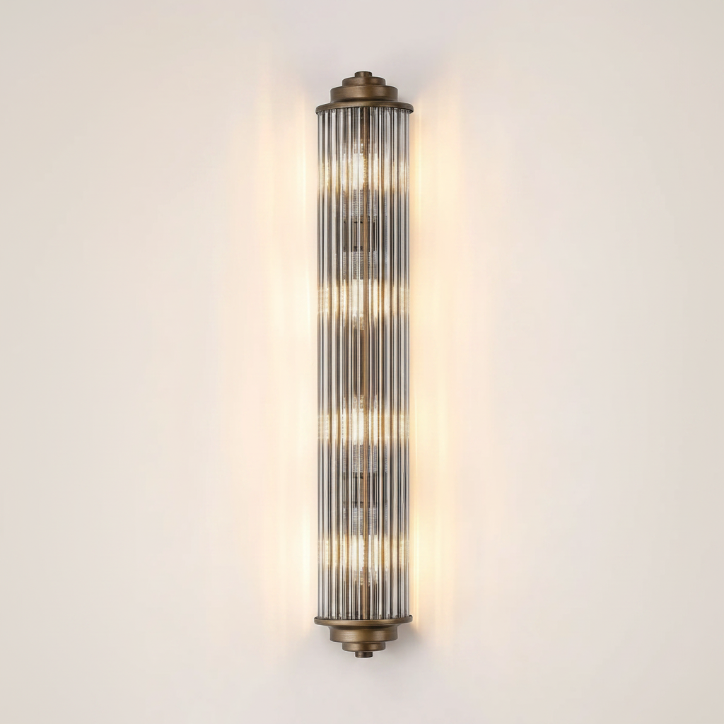 Vertical fluted glass wall sconce with brass accents and illuminated bulbs