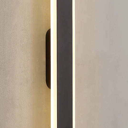 Close up of an illuminated vertical black and white wall light