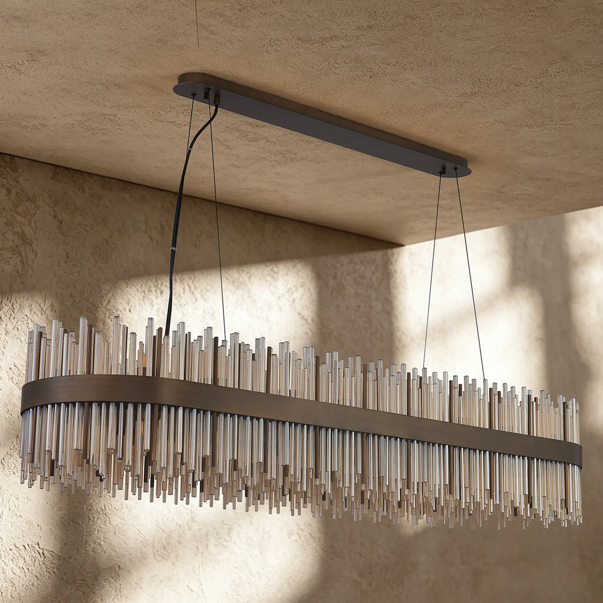 Rectangular chandelier with bronze frame and clear glass rods hanging at varying lengths