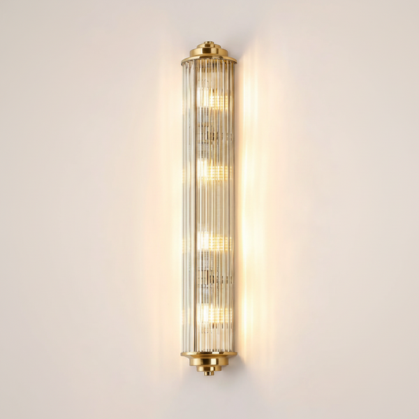 Vertical brass and fluted glass wall sconce with five illuminated bulbs