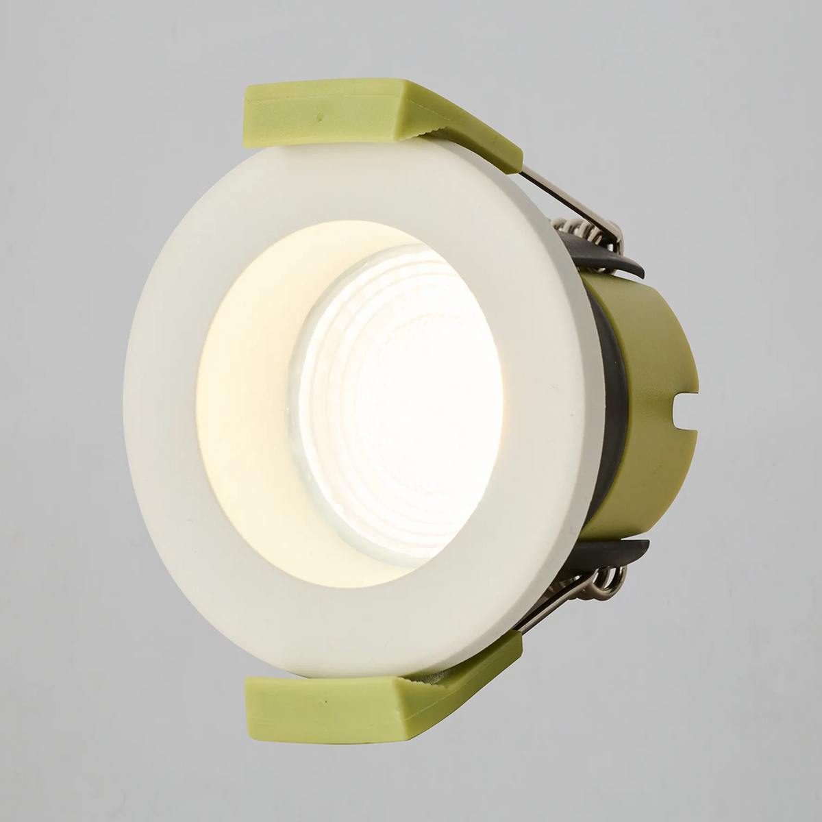 Warm white LED recessed light with a white trim and lime green clips, angled view