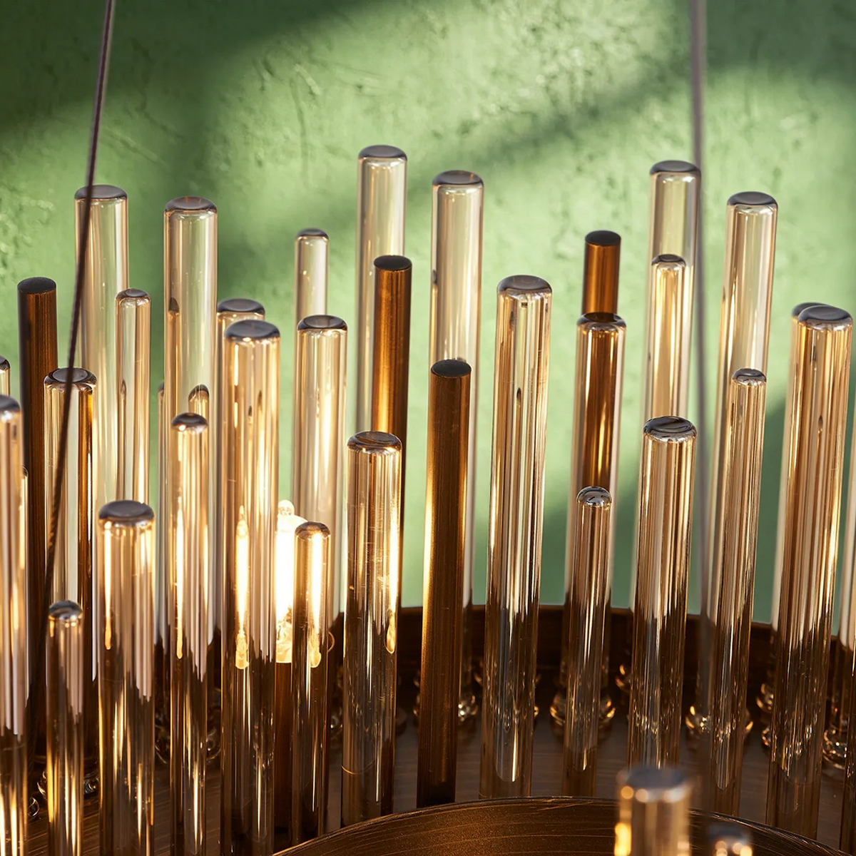 Close up of a chandelier with many glass tubes in varying heights and colors