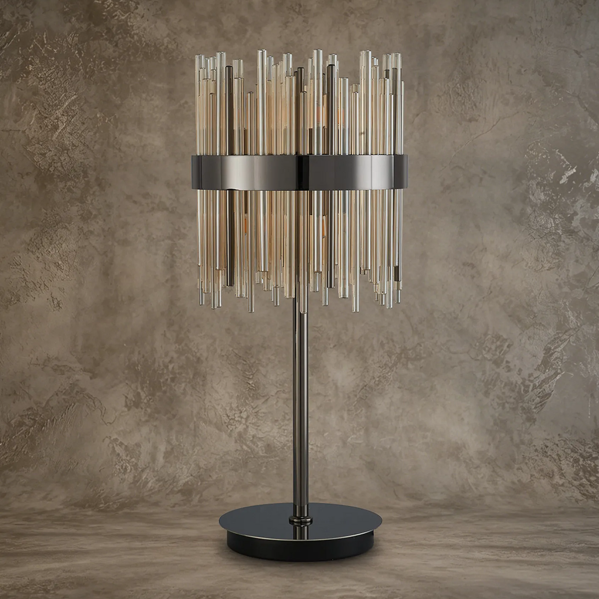Table lamp with a dark metal base and stem, and a cylindrical shade made of vertical glass rods