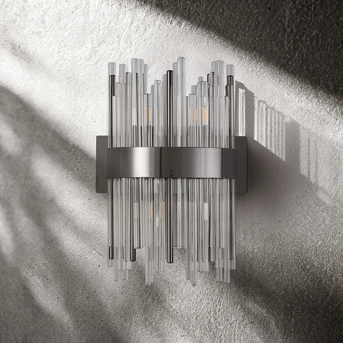 Wall sconce with clear glass rods and a dark metal band