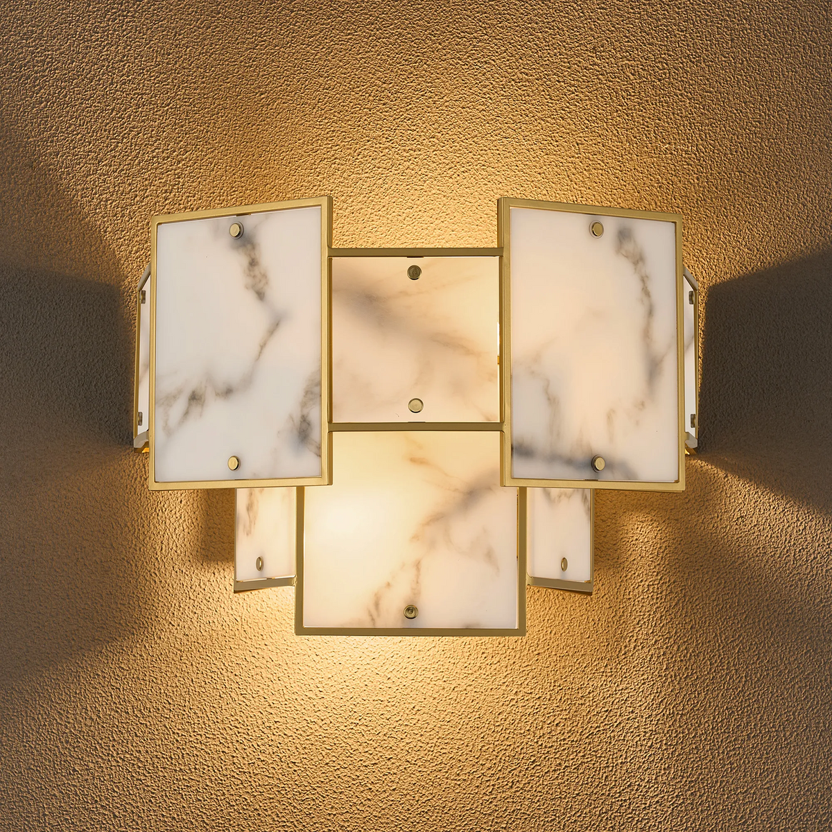 Wall sconce with gold frame and marble-patterned glass panels