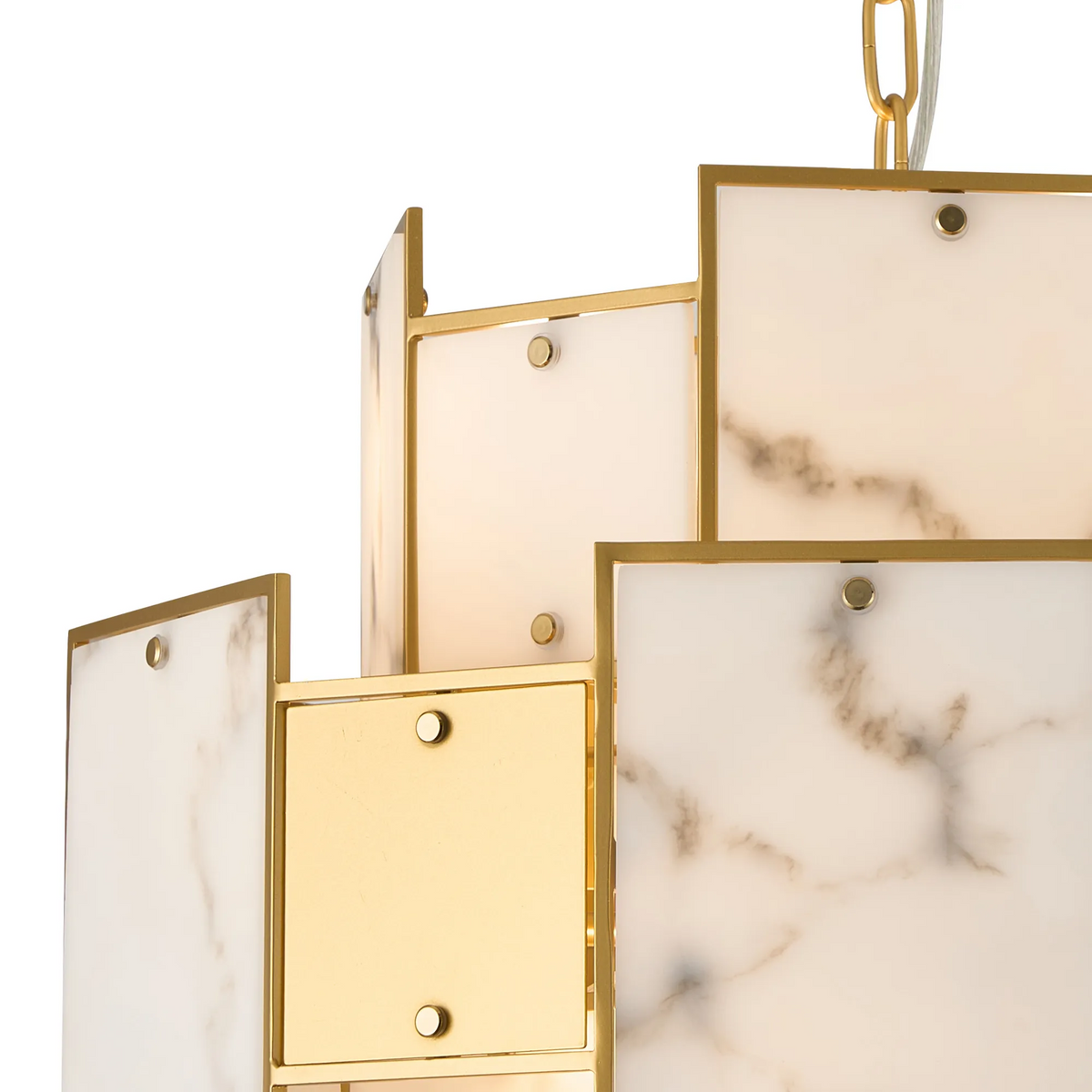 Close up of a gold chandelier with rectangular white marble panels