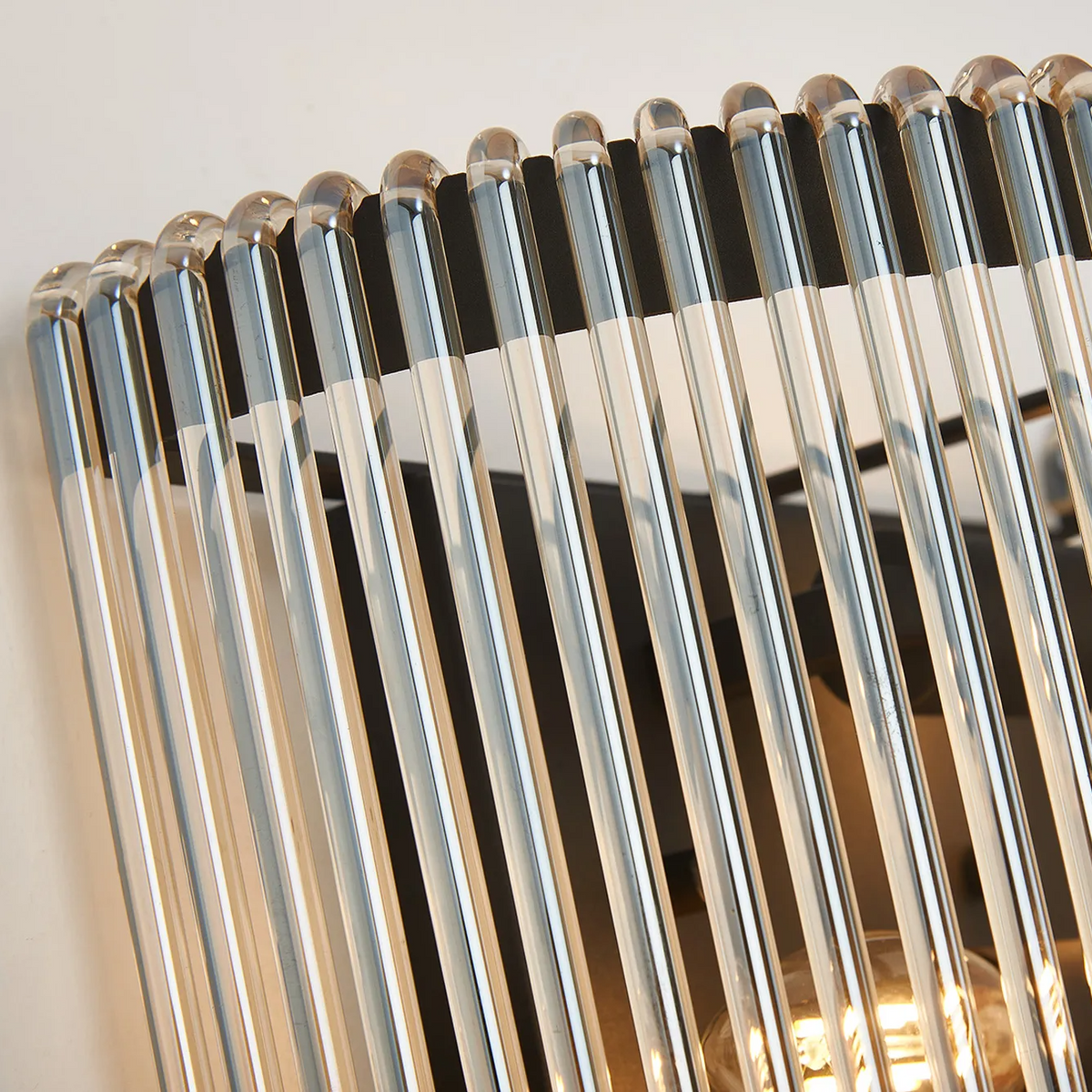 Lumiere Jevington medium wall light featuring vertical smoke brown glass rods on a black frame