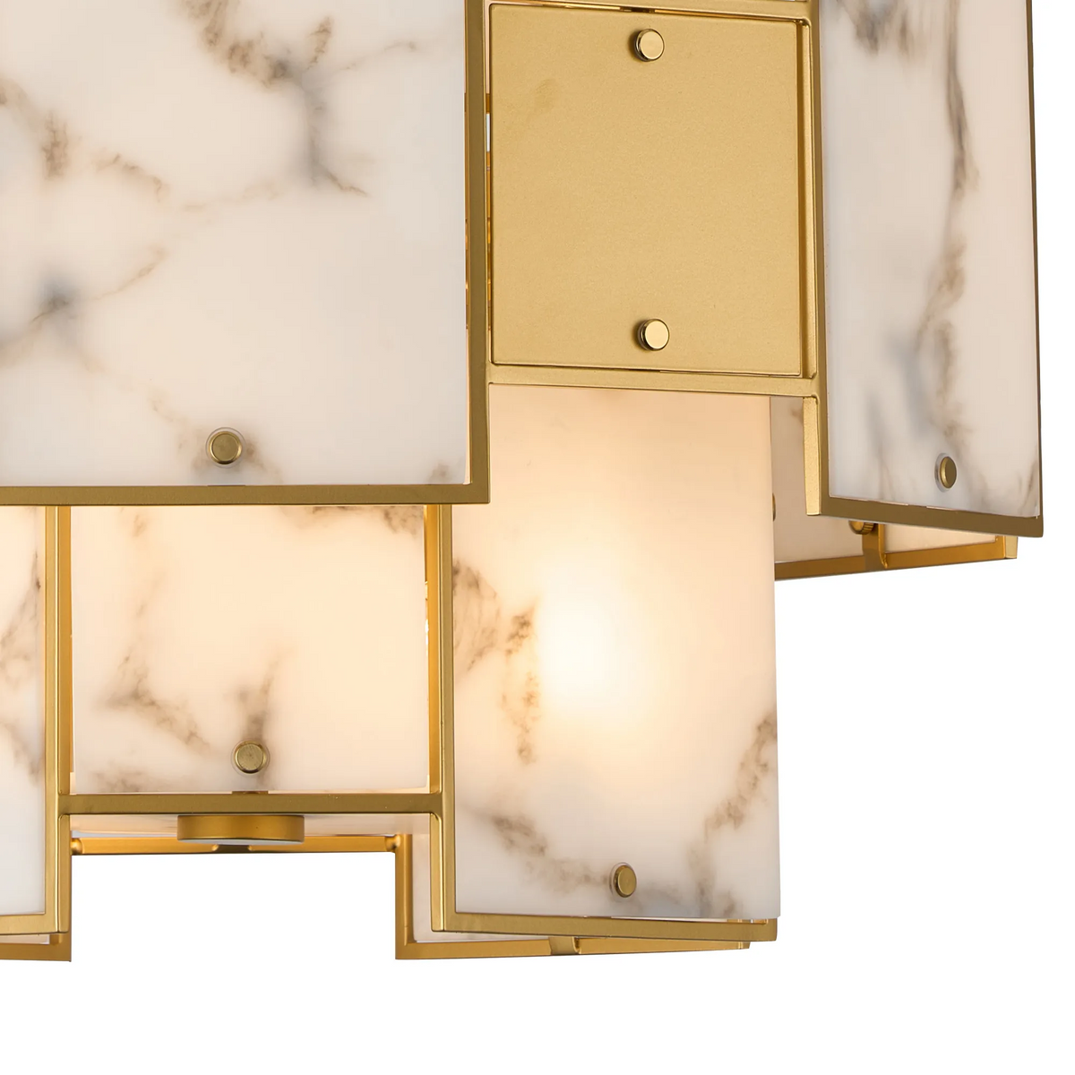 Close-up of a modern light fixture with white marble panels and gold-finished metal framing