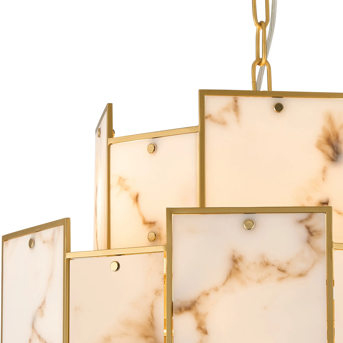Close up of a chandelier with rectangular white marble panels and gold frames