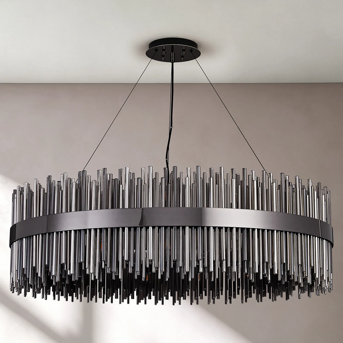 Round chandelier with a black frame and clear glass rods of varying lengths