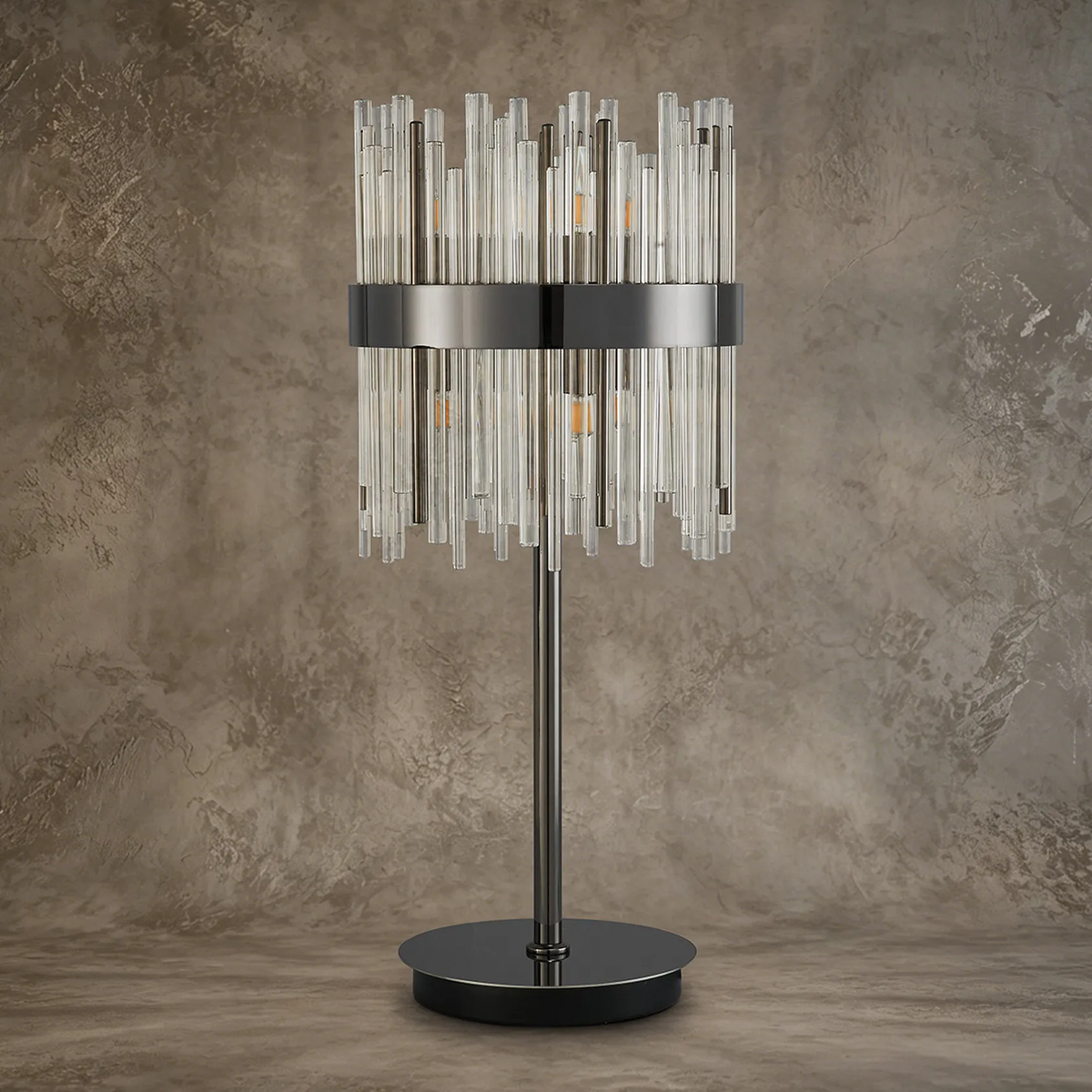 Table lamp with a black base and stand, and a cylindrical shade made of clear glass rods