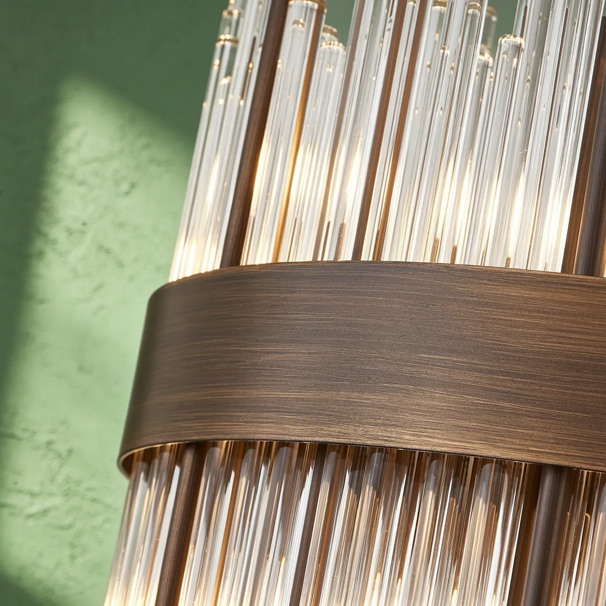 Close up of a bronze light fixture with clear glass rods