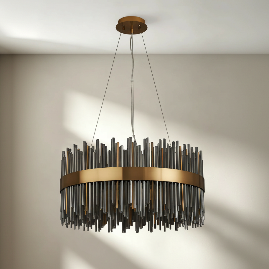 Round chandelier with bronze band and vertical glass rods in various lengths and shades of gray and bronze