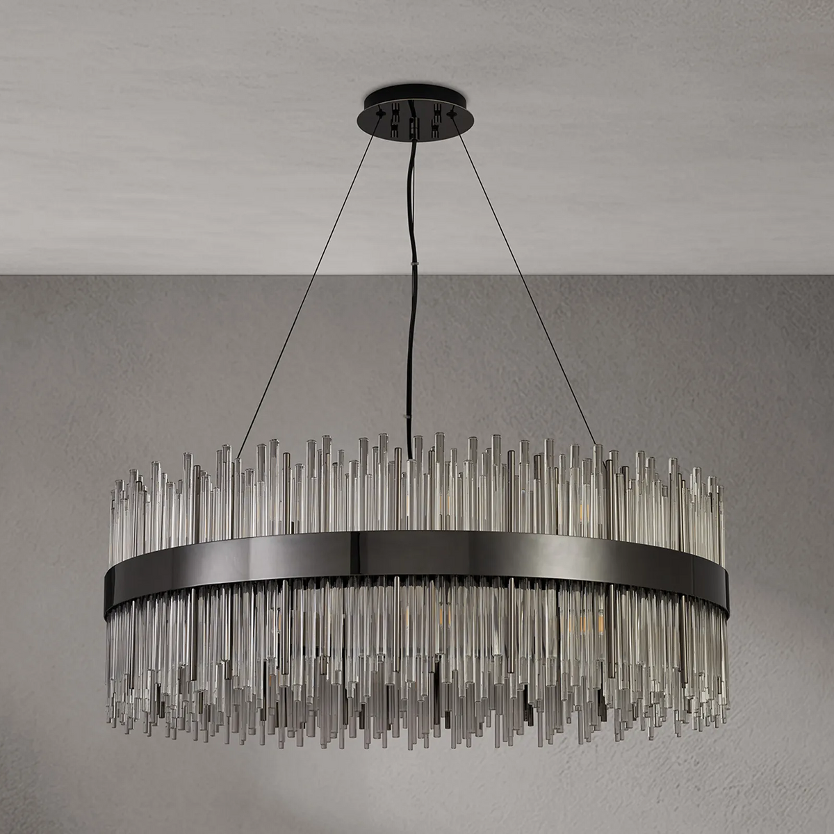 Round chandelier with a black metal band and clear glass rods hanging at varying lengths